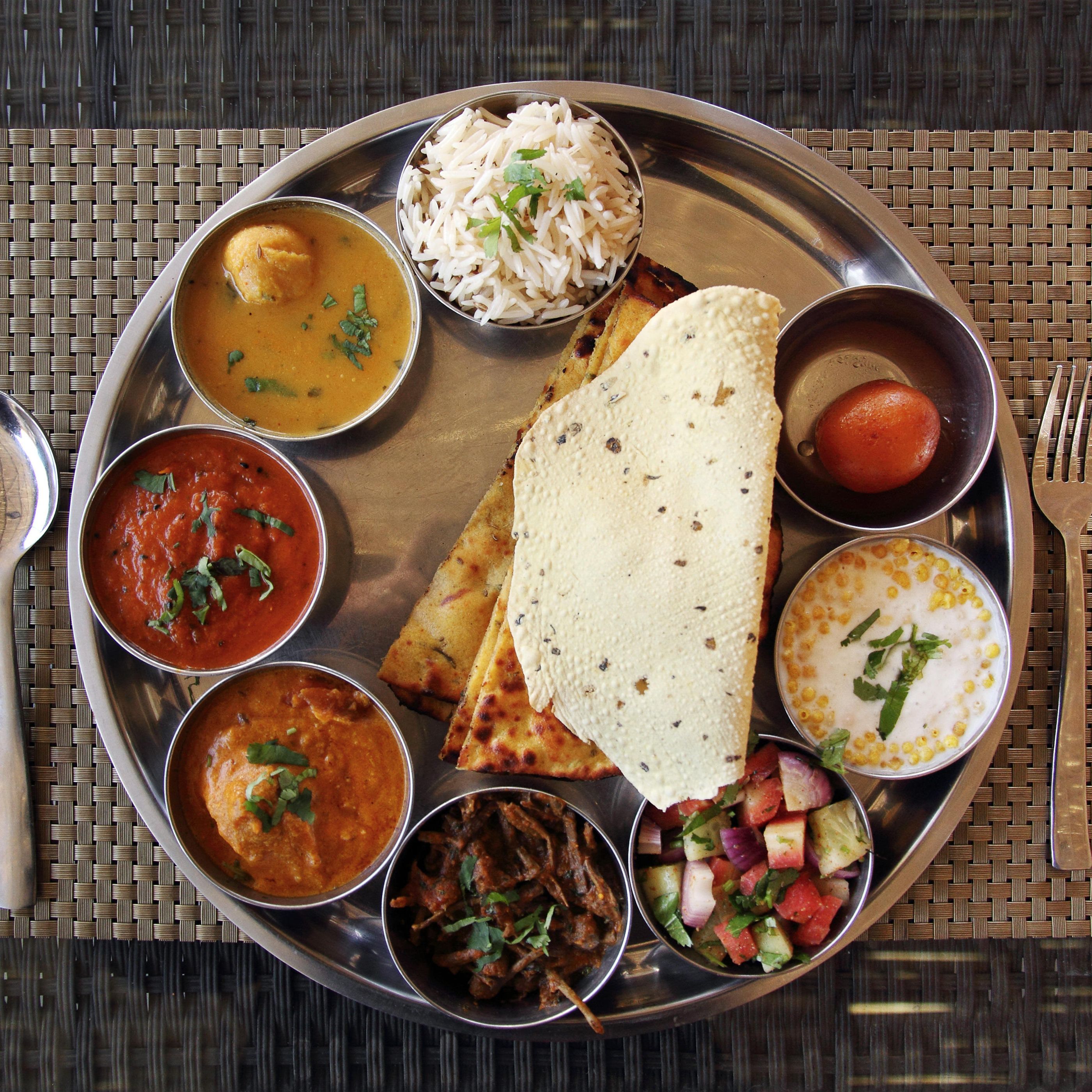 An abundant traditional Rajasthani thali with vegetables, dal, breads and sweets